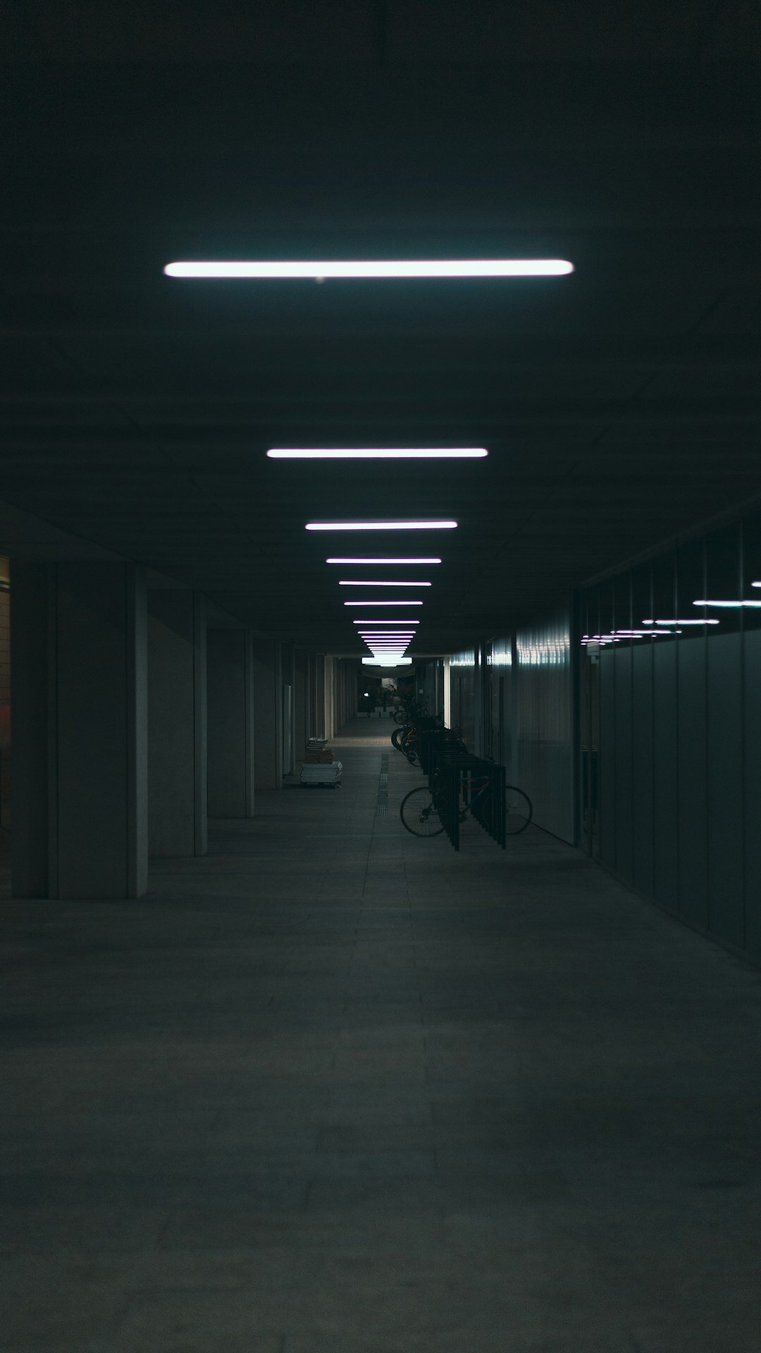 Employees walking through a modern office corridor in the evening